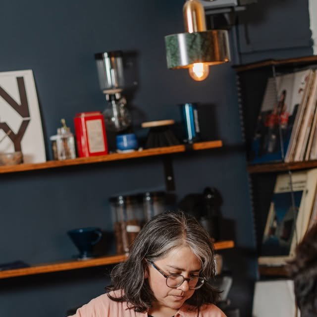 Barista preparando filtrados bajo la lámpara de Unity